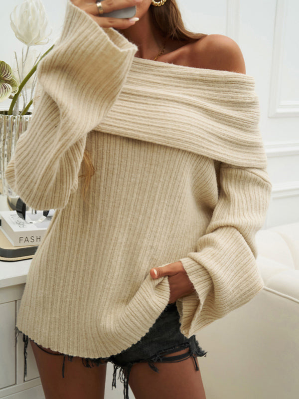 Beige off-shoulder sweater worn by a person indoors.